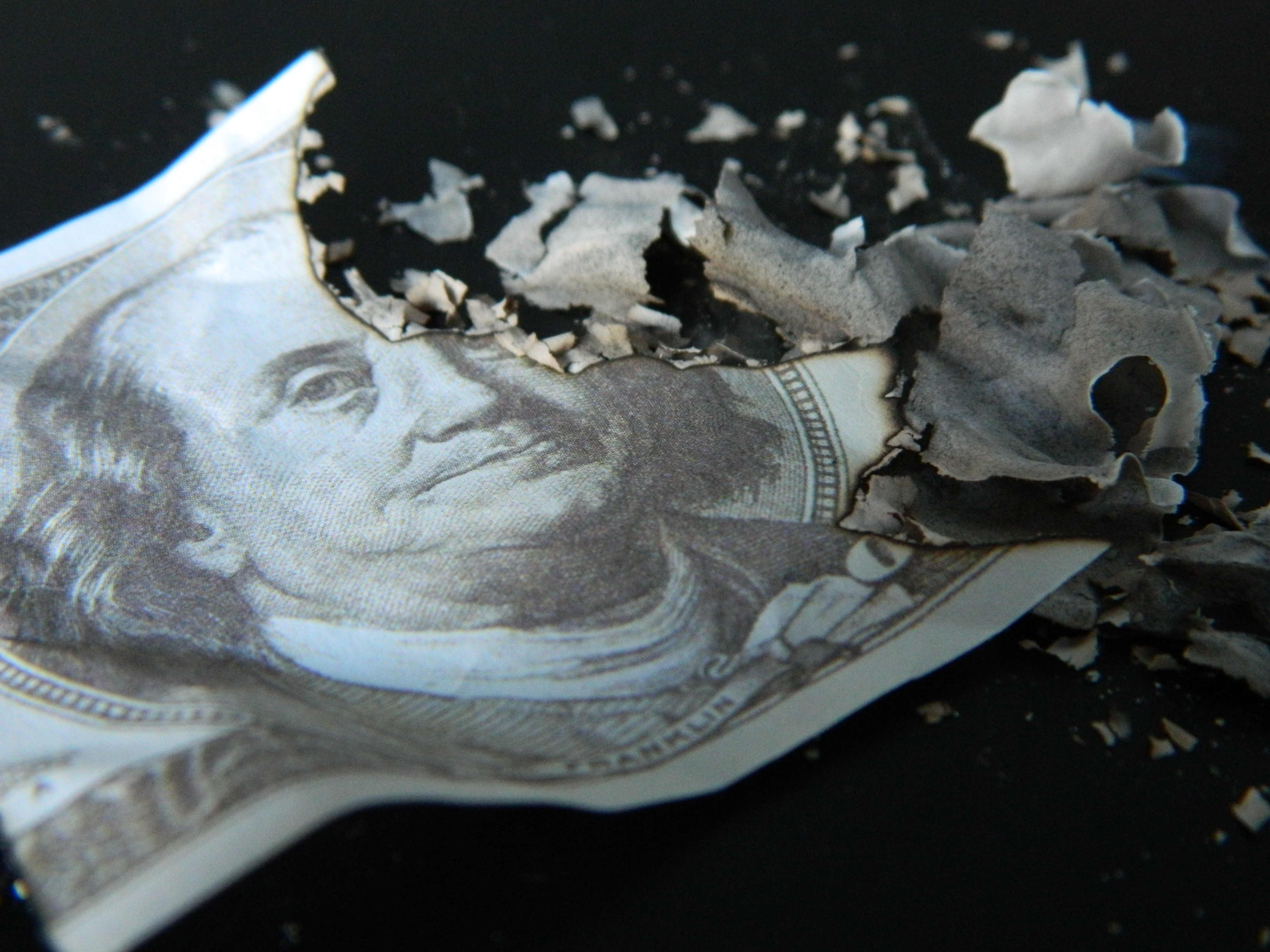 Burning hundred dollar bill